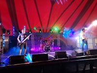 a band performs on stage in a tent