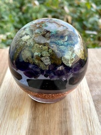 an amethyst crystal ball on a wooden table