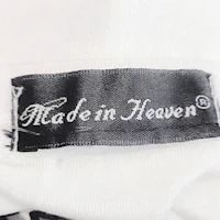 a white shirt with a label that says made in heaven