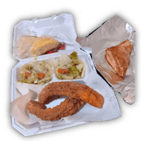 a tray of food with fried chicken and vegetables in it