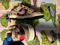 a pair of nike dunk low sneakers on a blanket