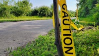 a caution tape on the side of a road