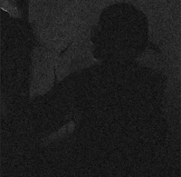 a black and white photo of a person in a dark room