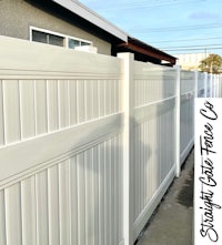 a white picket fence on the side of a street