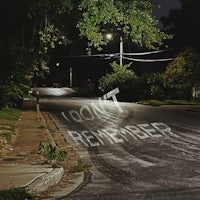 a street with a sign that says don't remember