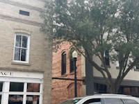 a black suv parked in front of a building
