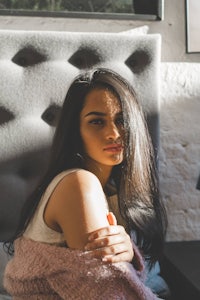 a young woman sitting on a bed