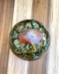 an agate ball on a wooden table