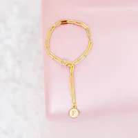 a gold plated ring with a letter engraved on it