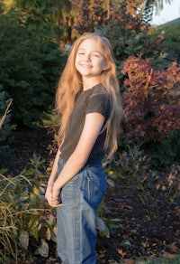 a young girl wearing jeans and a t-shirt