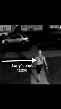 a black and white photo of a man with a tattoo on his back