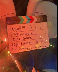 a clapper board with the words all dressed up on it
