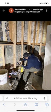 a man is working on a wall in a home
