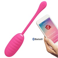 a woman is holding up a pink bluetooth sex toy