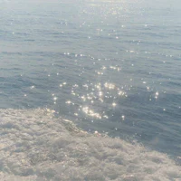 the sun shines through the water on a boat