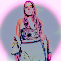 a woman in a colorful dress posing in front of a pink background