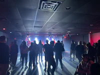 a crowd of people standing in a dark room