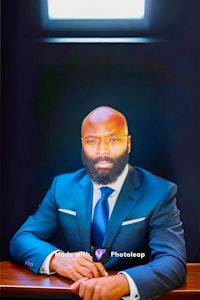 a man in a suit sitting at a table