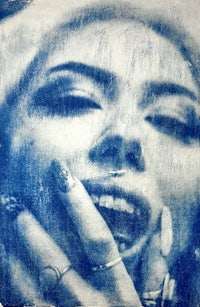 a blue and white photo of a woman with a ring on her finger