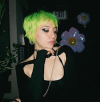a woman with green hair posing for a photo