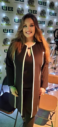 a woman in a black and white jacket posing for a photo