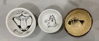 three bowls with drawings of a cat and a fish