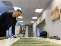 a man cleaning a table in an office