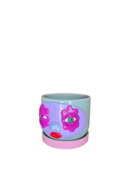 a blue and pink flower pot with a face on it