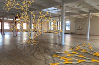 a room filled with yellow wires and a wooden floor