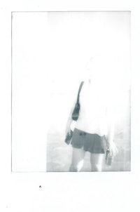 a black and white photo of a woman holding a surfboard