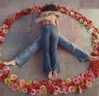 two people hugging in a circle of flowers