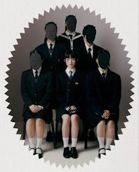 a group of girls in school uniforms posing for a picture