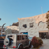 a mercedes benz parked in front of a building