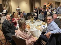 a group of people sitting around a table at a banquet