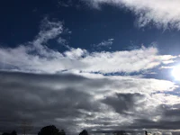 the sun is shining through a cloudy sky