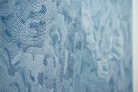 a close up of a blue painting on a wall