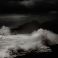 a black and white photograph of a stormy ocean