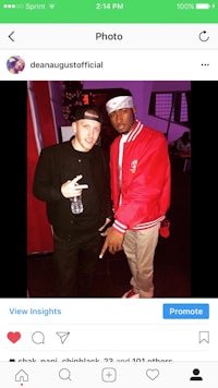 a man is posing with a man in a red jacket