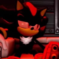 sonic the hedgehog is sitting in a dark room