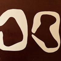 a pair of white shapes on a brown background