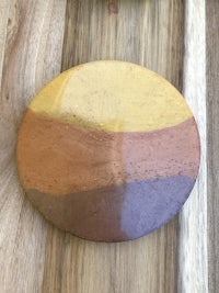 a ceramic plate with a yellow, orange, and brown color