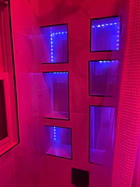 a bathroom with blue and purple lights in the ceiling