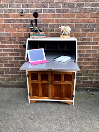 a desk with a laptop on top of it