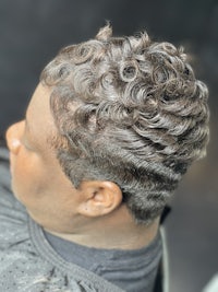 a man with curly hair in a salon