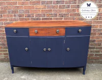 a blue and wood sideboard with drawers