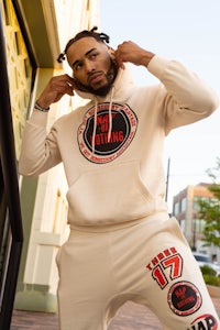 a man wearing a white hoodie and sweatpants