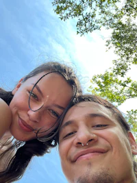 a man and woman taking a selfie in the sky