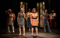 a group of women standing on a stage