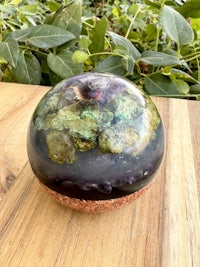 an amethyst sphere sitting on top of a wooden table