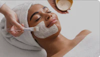 a woman getting a facial treatment at a spa